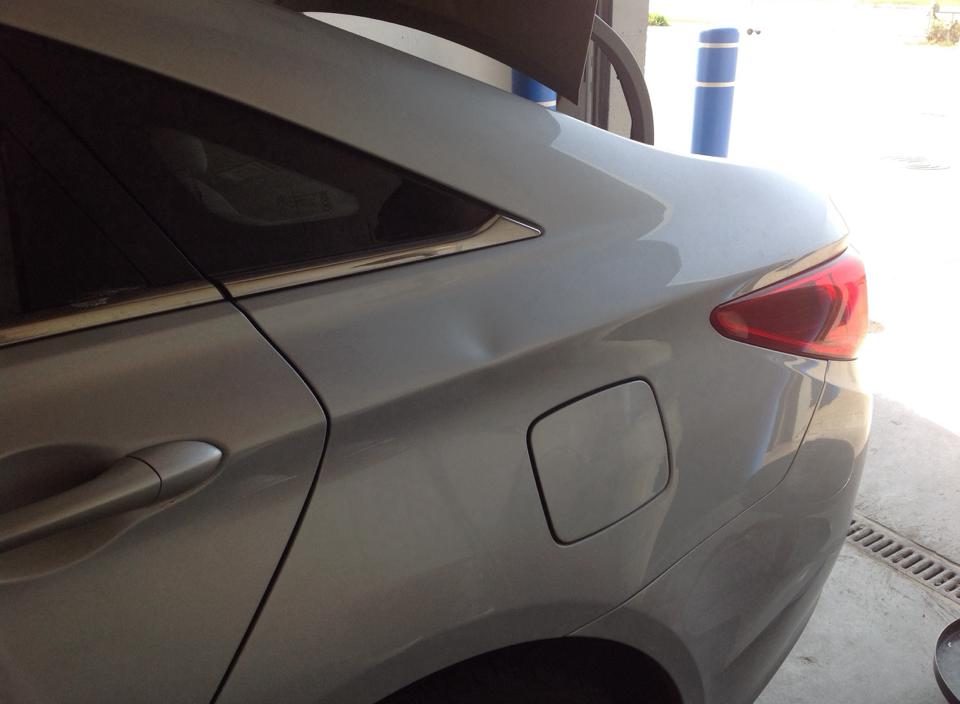 The same silver SUV rear body panel after repair, smooth and clean